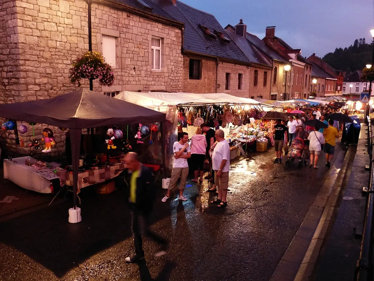 There are group of people walking. This looks like a stroller. I can see few people holding...