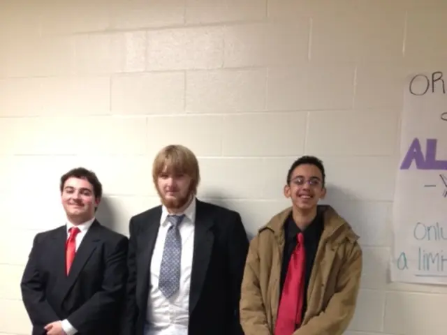 In this picture we can see three men wore blazers, ties, shoes and standing and on the floor and in...